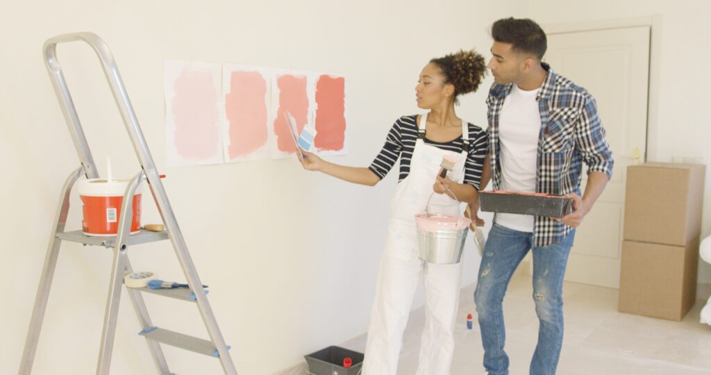 Image of couple trying different paint colors on their home walls