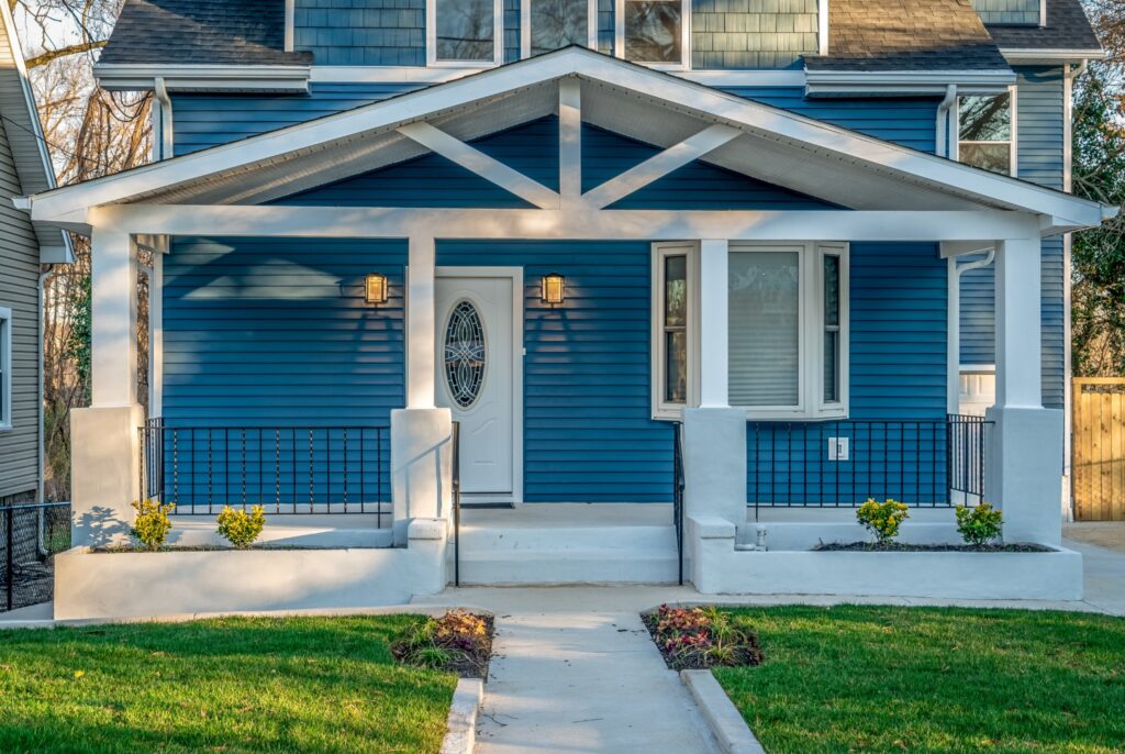 Image of a beautiful blue Craftsman-style home.