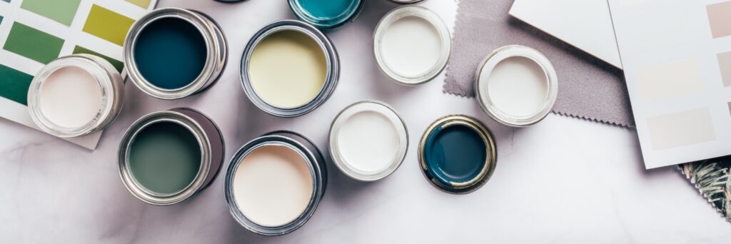Image of multiple open paint cans to convey concept of choosing colors for home