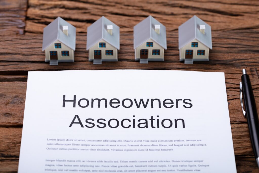 Image of model houses on a table with homeowners association rules