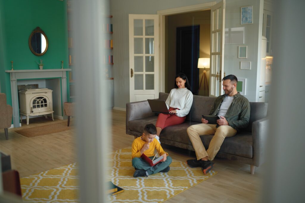Image of family sitting together in a home with colorful walls.